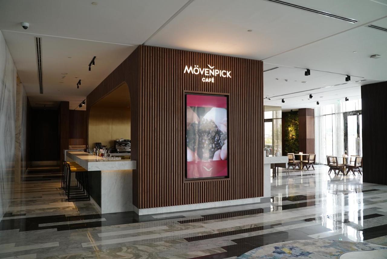 Movenpick Jumeirah Village Triangle Dubai Buitenkant foto Mövenpick Café in the lobby of the Kempinski Hotel, Amman, Jordan